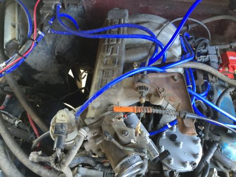 1989 Ford Bronco - Close-up view of a vehicle's engine bay, highlighting various hoses and components.