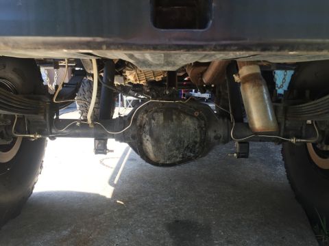 1989 Ford Bronco - Underside view of a 1989 Ford Bronco, highlighting the rear axle, leaf springs, and exhaust components.