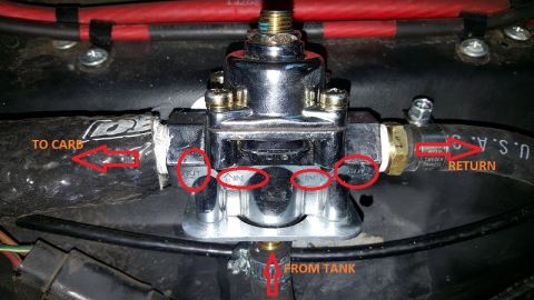 1978 Ford Bronco - Close-up of a fuel pressure regulator, showing its connections and labels.