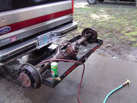 1989 Ford Bronco - Rear axle assembly on a trailer, attached to a Ford truck. Oregon license plate SYB 064 is visible.