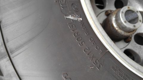 1996 Ford Bronco - A detailed view of a vehicle's wheel and tire, showing the tread and rim design.