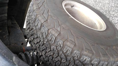 1996 Ford Bronco - Close-up of a spare tire and suspension components, likely from an off-road vehicle.