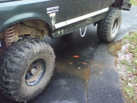 1989 Ford Bronco - This lifted 1989 Ford Bronco features large off-road tires and a prominent side stripe.