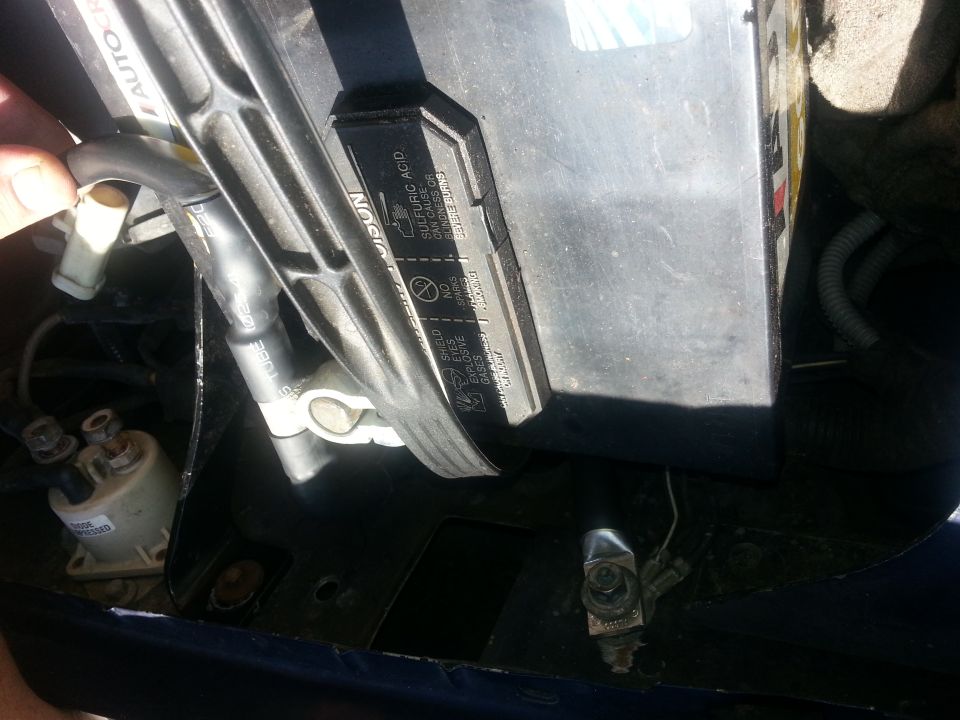 Installed battery with cable terminal and printed manufacturer label