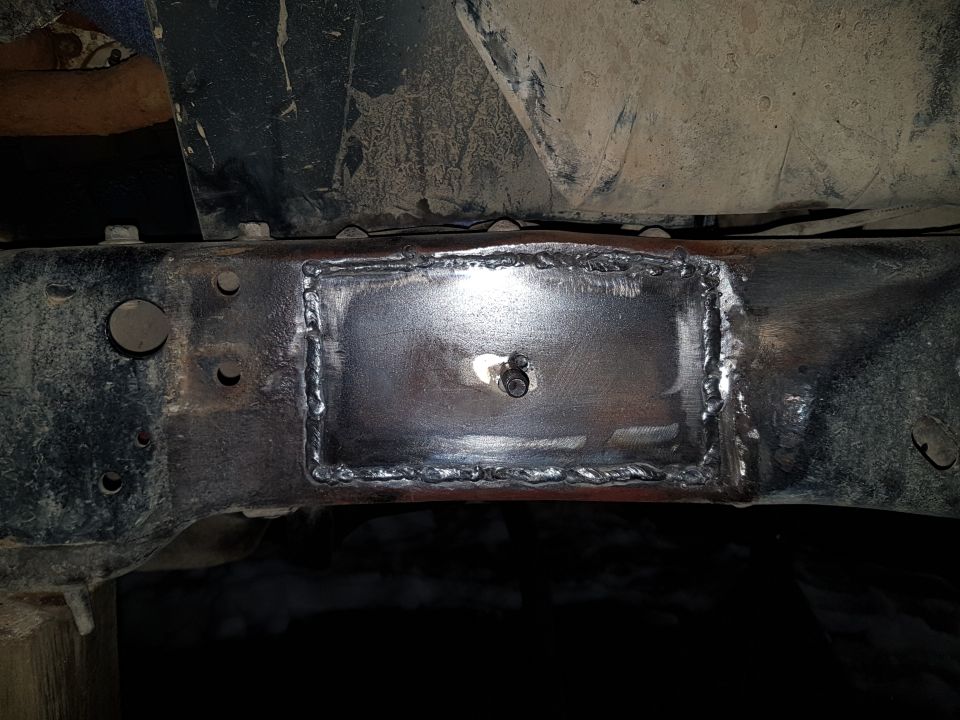 Welded patch plate on a vehicle frame.