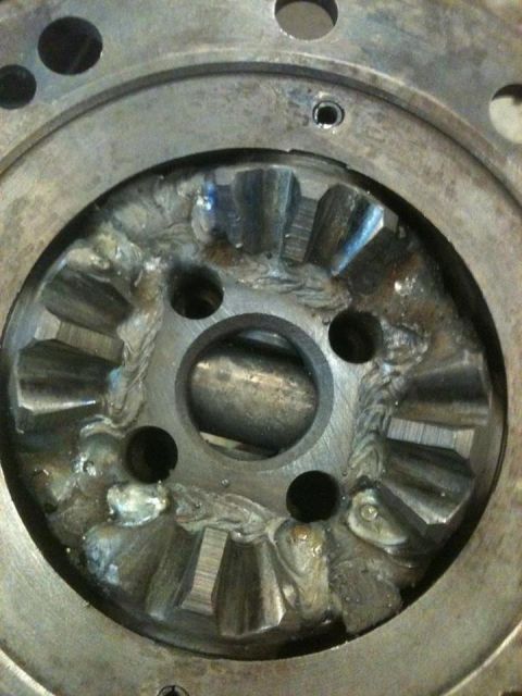 1984 Ford Bronco - This is a close-up view of the differential gears within a vehicle's axle housing. The gears show signs of significant modification, with v…