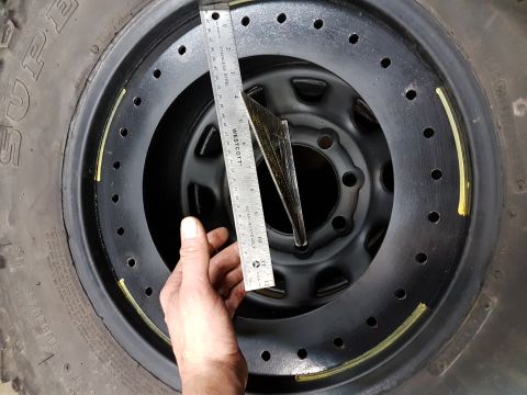 1984 Ford Bronco - Close-up view of a vehicle's brake rotor and caliper assembly.