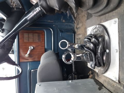 1984 Ford Bronco - Close-up view of a vehicle's undercarriage, focusing on suspension parts and a wheel.