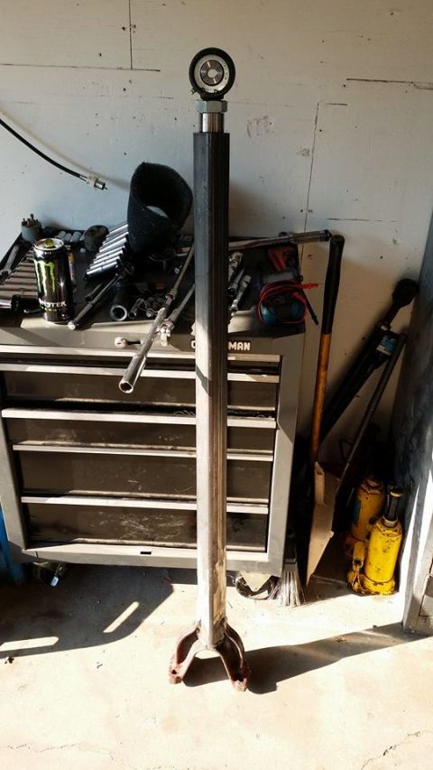 1984 Ford Bronco - A metal part with a gauge on top, likely a component for a larger machine or vehicle.