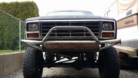 1984 Ford Bronco - This lifted Ford truck features a custom front bumper and off-road tires.