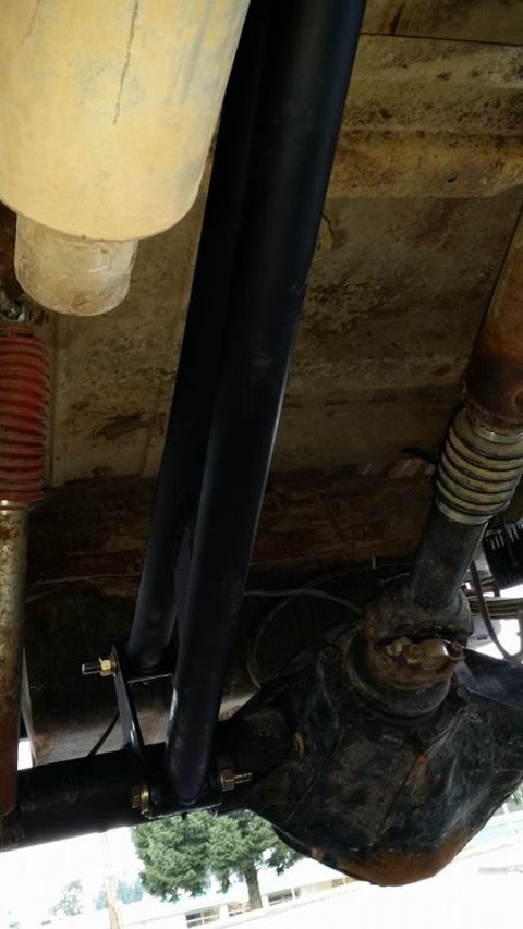 1984 Ford Bronco - Detail of a black roll cage tube and its attachment points.
