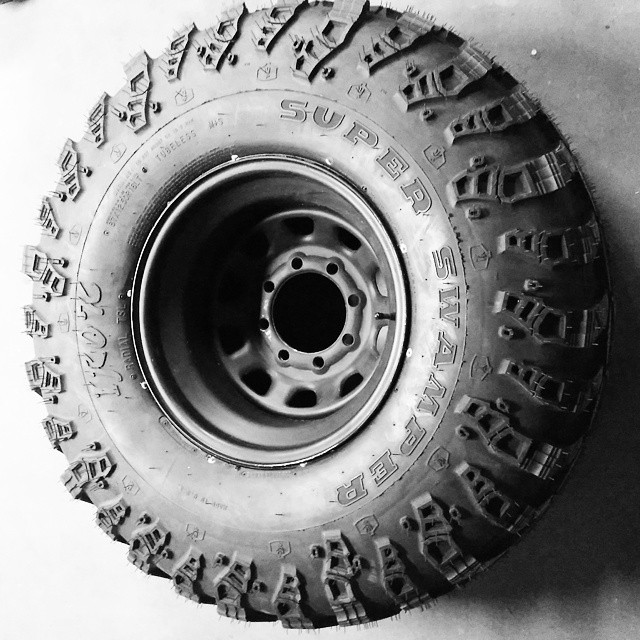 Super Swamper tire with aggressive tread pattern on a steel rim