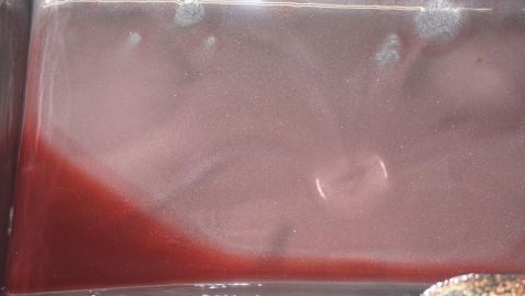 1984 Ford Bronco - Transmission fluid sample showing metallic particulate contamination.