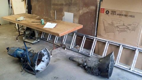 1984 Ford Bronco - Two transmission assemblies are visible on the floor, suggesting automotive repair or parts.