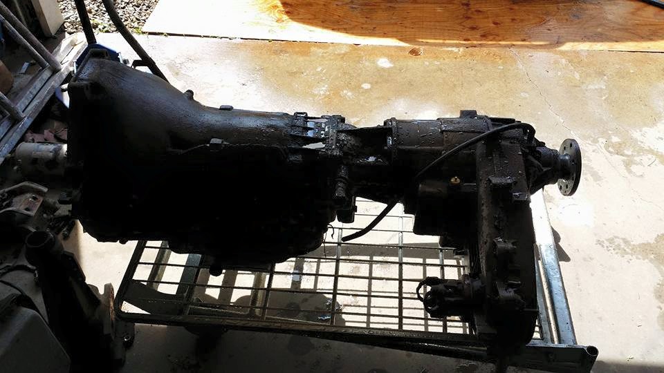 Transmission and transfer case assembly on a metal rack