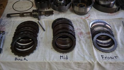 1984 Ford Bronco - Disassembled transmission clutch plates are laid out and labeled for identification.