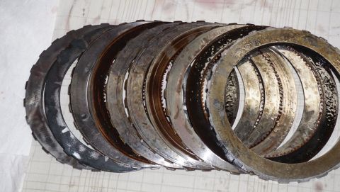 1984 Ford Bronco - Worn transmission clutch plates are shown, indicating a need for replacement.