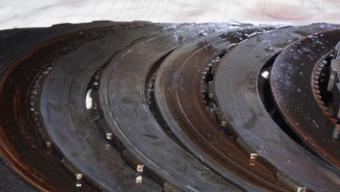 1984 Ford Bronco - Worn clutch plates, likely from a transmission, show signs of heavy use and oil contamination.