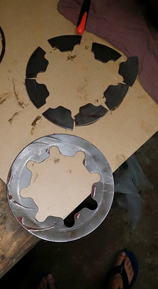 Clutch plates laid out on cardboard, one set broken into pieces