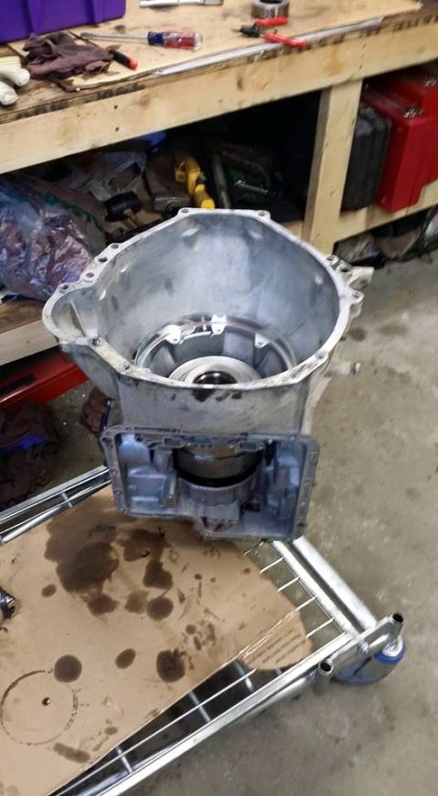 1984 Ford Bronco - Disassembled automatic transmission housing sits on a cart, awaiting repair or reassembly.