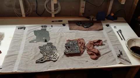 1984 Ford Bronco - Disassembled transmission valve body and associated parts are laid out on a towel, ready for cleaning or reassembly.