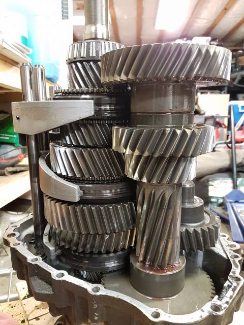 1984 Ford Bronco - Close-up view of the internal gears of a transmission, disassembled from its casing.