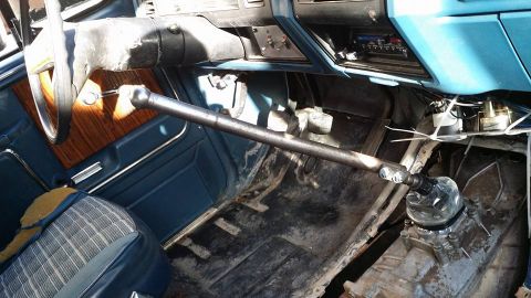 1984 Ford Bronco - The interior of this vehicle features a custom shifter and a wood-grain door panel, but does not appear to be a 1984 Ford Bronco.