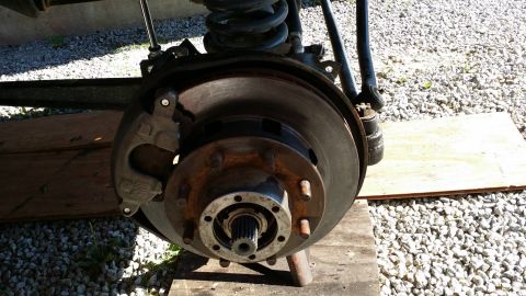 1984 Ford Bronco - Close-up view of a vehicle's front brake assembly, showing the rotor, caliper, and hub.