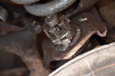 1984 Ford Bronco - This image shows a close-up view of a vehicle's suspension system, specifically a ball joint assembly.