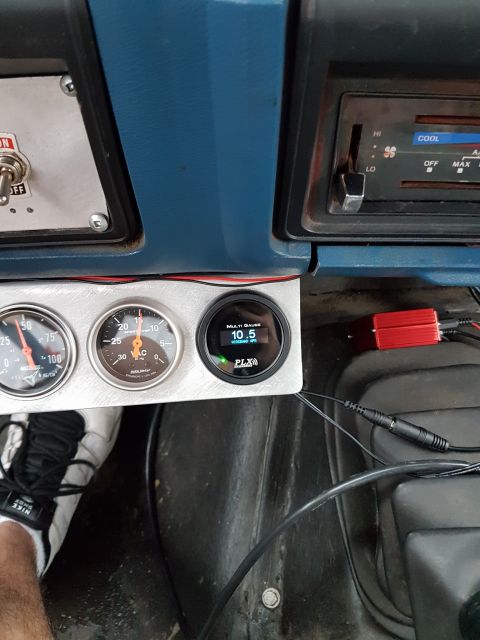 1984 Ford Bronco - Interior view of a vehicle's dashboard multiple gauges and an air conditioning control panel.