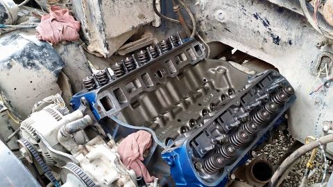 1984 Ford Bronco - Engine block and alternator in a disassembled state, likely undergoing repair or rebuild.
