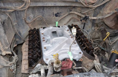 1984 Ford Bronco - Close-up view of an engine's intake manifold and valve covers, with surrounding engine components.
