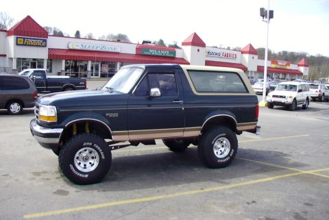 1995 Ford Bronco - Lifted 1995 Ford Bronco parked in a shopping center lot.