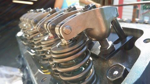 1984 Ford Bronco - Close-up of an engine's valve train, showing rocker arms and springs.