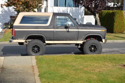 1984 Ford Bronco - This lifted Ford Bronco has a two-tone paint scheme and aftermarket wheels.