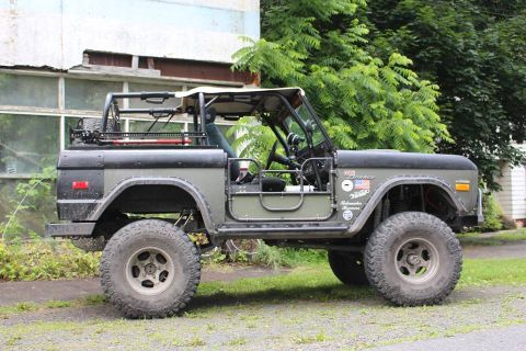 1972 Ford Bronco - This 1972 Ford Bronco features a roll cage, off-road tires, and a two-tone olive green paint scheme.