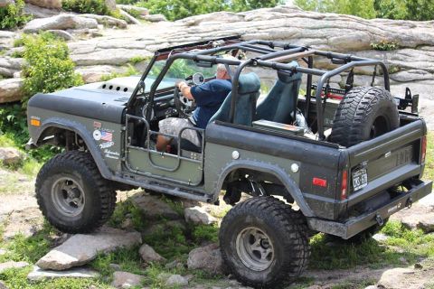 1972 Ford Bronco - Modified 1972 Ford Bronco navigates a rocky off-road trail.