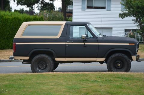 1984 Ford Bronco - This Ford Bronco has a two-tone paint scheme with black and tan colors.