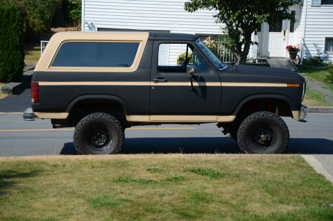 1984 Ford Bronco - This lifted Ford Bronco features a two-tone paint scheme and aggressive off-road tires, suggesting it's ready for adventure.