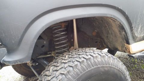 1984 Ford Bronco - Suspension components visible in the wheel well of an off-road vehicle.