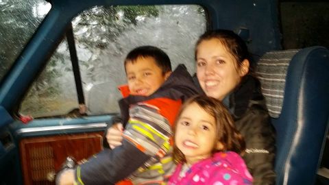 1984 Ford Bronco - Family members are seated inside a vehicle during what appears to be inclement weather.