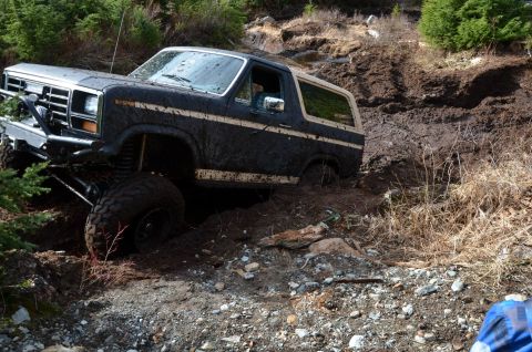 1984 Ford Bronco - This Ford Bronco is stuck deep in mud on an off-road trail.