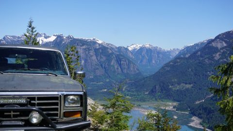 1984 Ford Bronco - Ford Bronco parked at a scenic mountain overlook, showing the front grille and headlights.