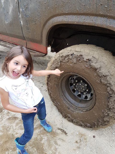 1984 Ford Bronco - Muddy tire and girl's excited reaction after off-roading.