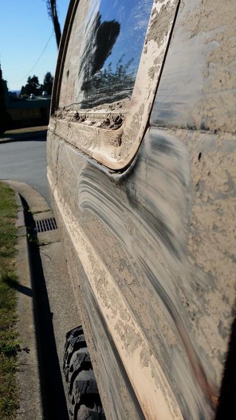1984 Ford Bronco - This vehicle appears to have recently been off-roading, as evidenced by the thick layer of mud covering its exterior.