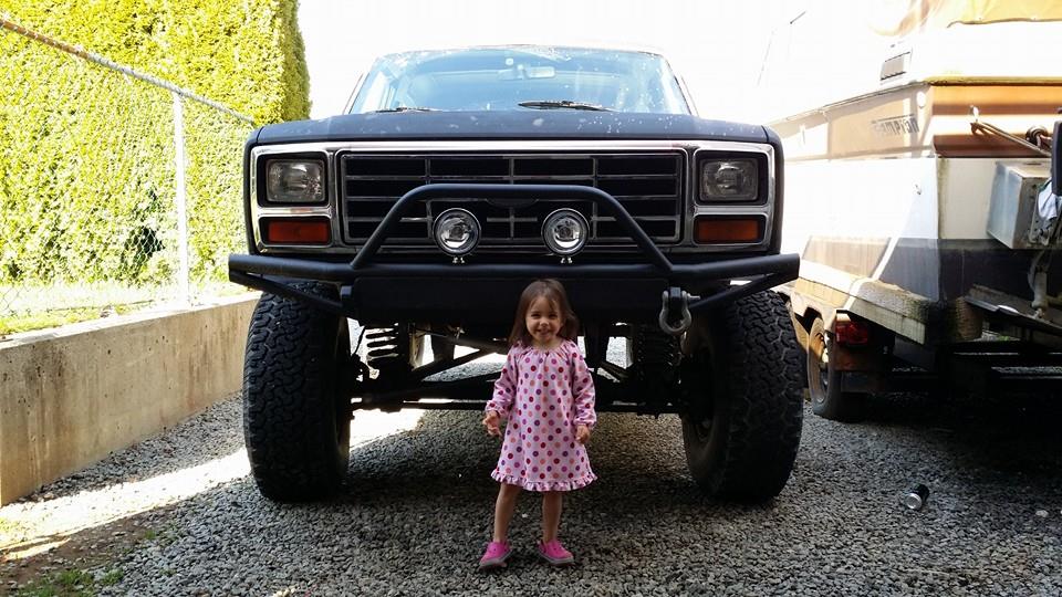 Girl standing in front of lifted Ford Bronco with bull bar