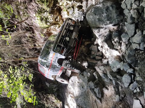 1984 Ford Bronco - This modified SUV navigates a challenging rocky terrain, demonstrating its off-road capabilities.