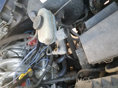 1994 Ford Bronco - Engine bay components including a Ford power distribution box and brake fluid reservoir are visible.