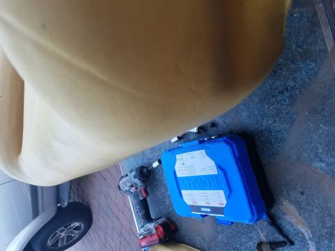 1994 Ford Bronco - Impact wrench and blue tool case on a tiled floor, possibly for vehicle maintenance.