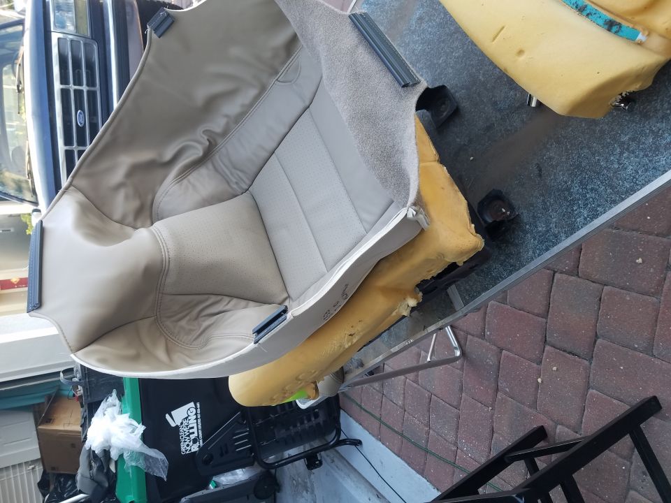 Car seat on table, with front of a truck visible behind it